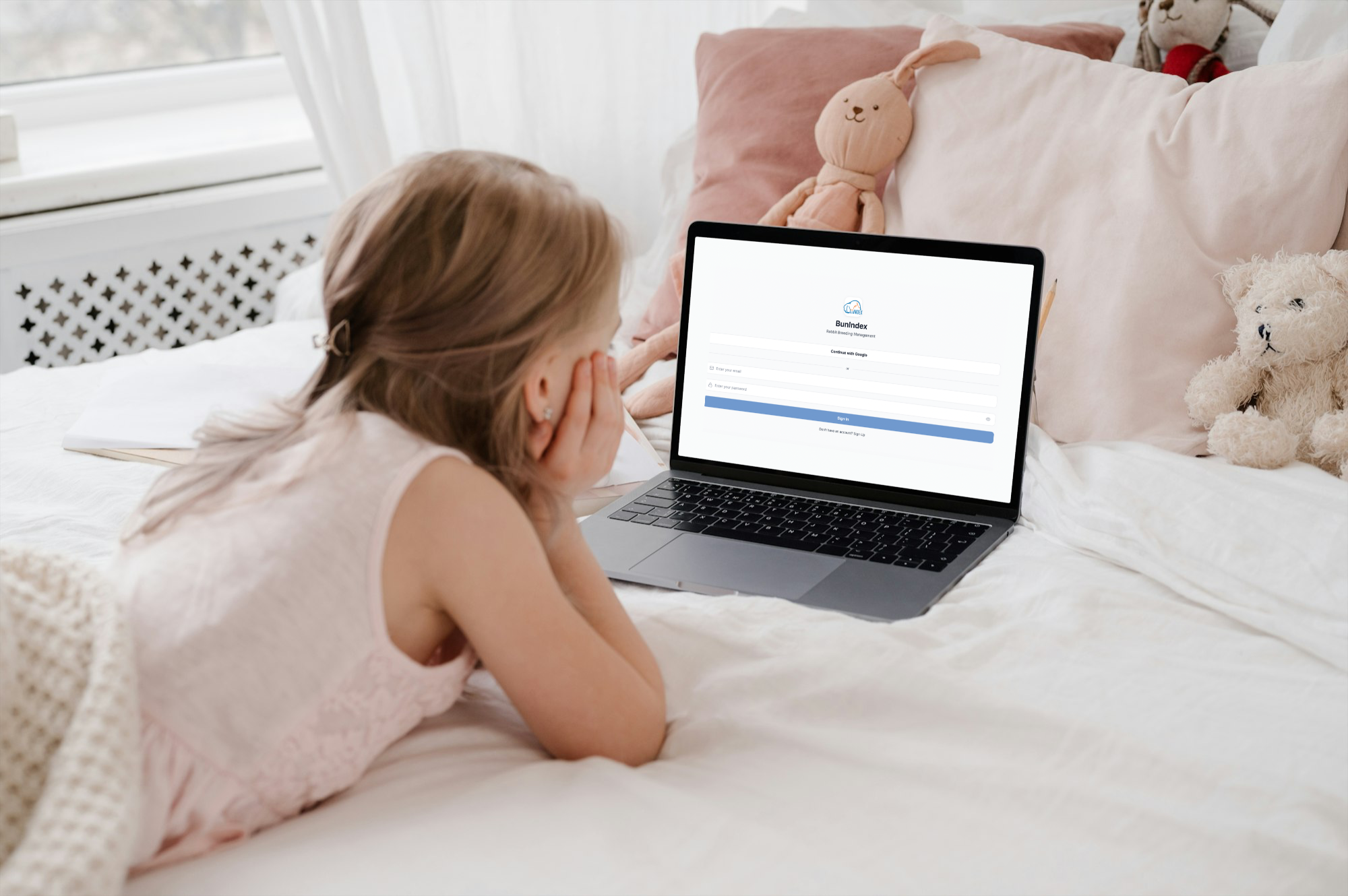 Young girl using laptop with BunINDEX login screen